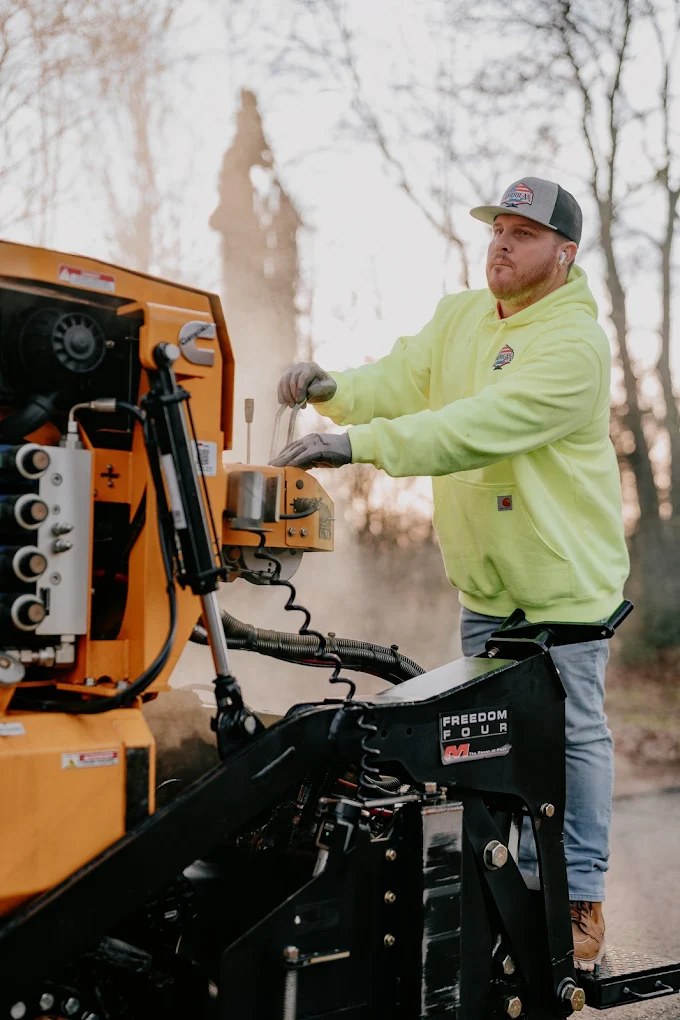 American Asphalt crew member running the paver on a Tennessee job at sunrise