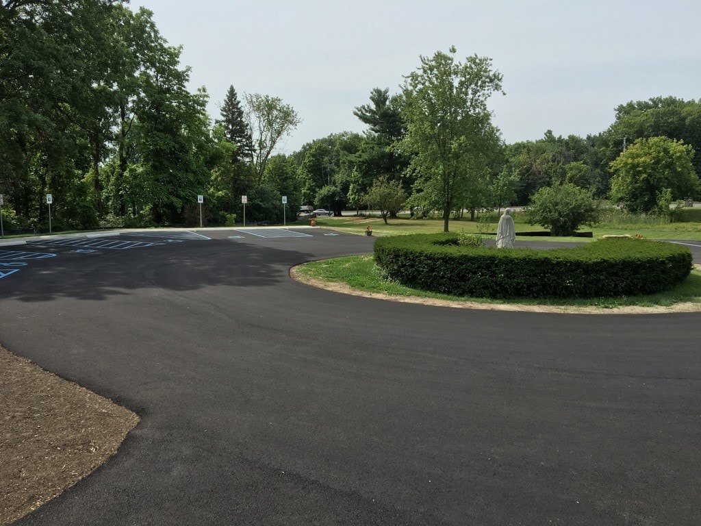 Commercial parking lot freshly sealcoated to a glossy black finish